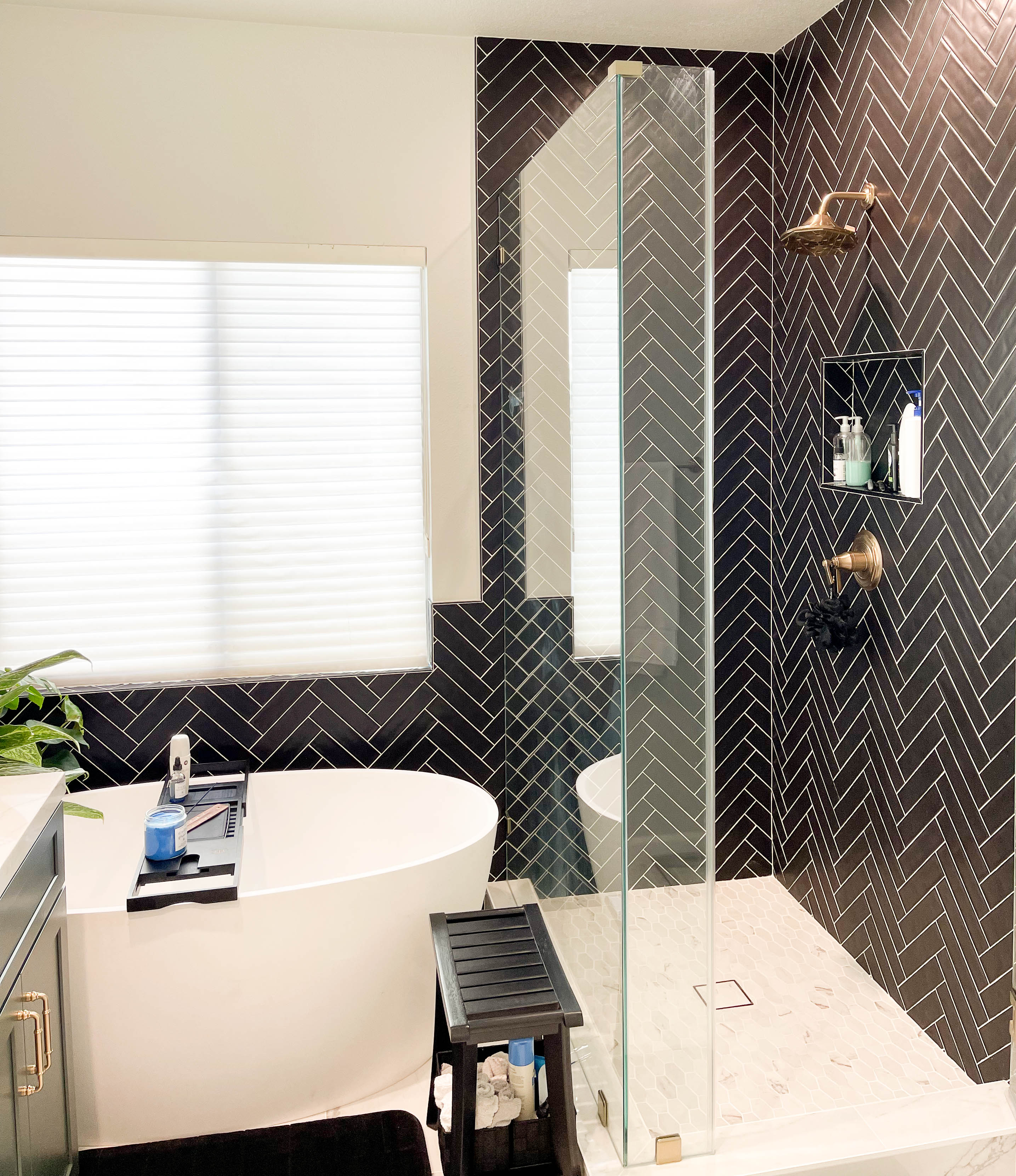 Gold-bathroom-accessories-on-black-subway-tile