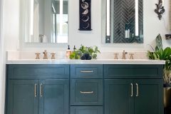 Green-bathroom-cabinets-with-gold-accessories
