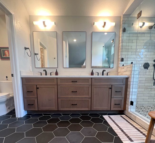 Wood-toned-master-vanity-with-black-fixtures