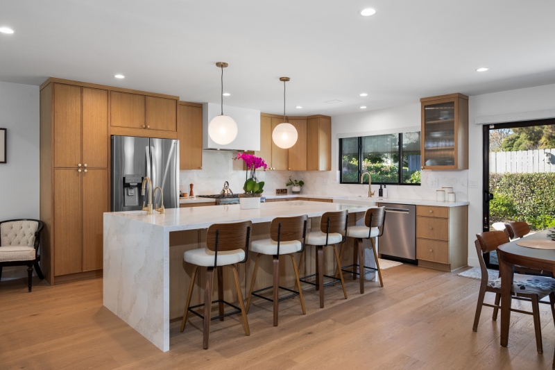 Warm-Wood-Cabinetry-with-waterfall-countertops
