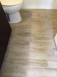 flooring contractor uses wood-look tiles in bathroom