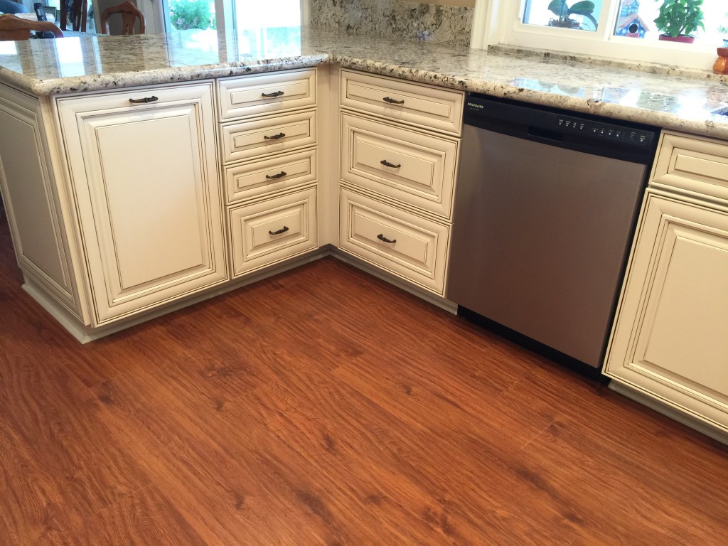 kitchen renovation company installs wood floor to contrast with shaker cabinets