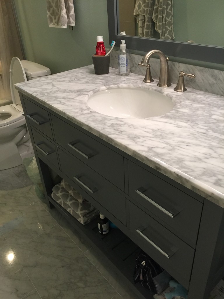 renovation contractor uses grey counter top inn bathroom for timeless look