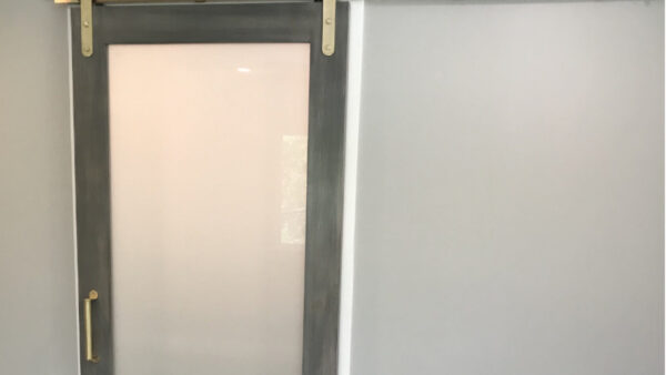 Custom grey barn door with obscured glass and gold track