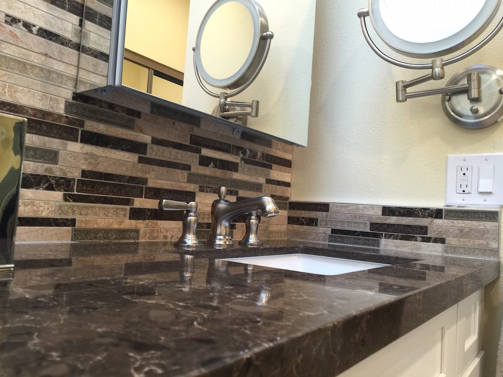 Bathroom contractor mounts makeup mirror on wall to maximize use of space