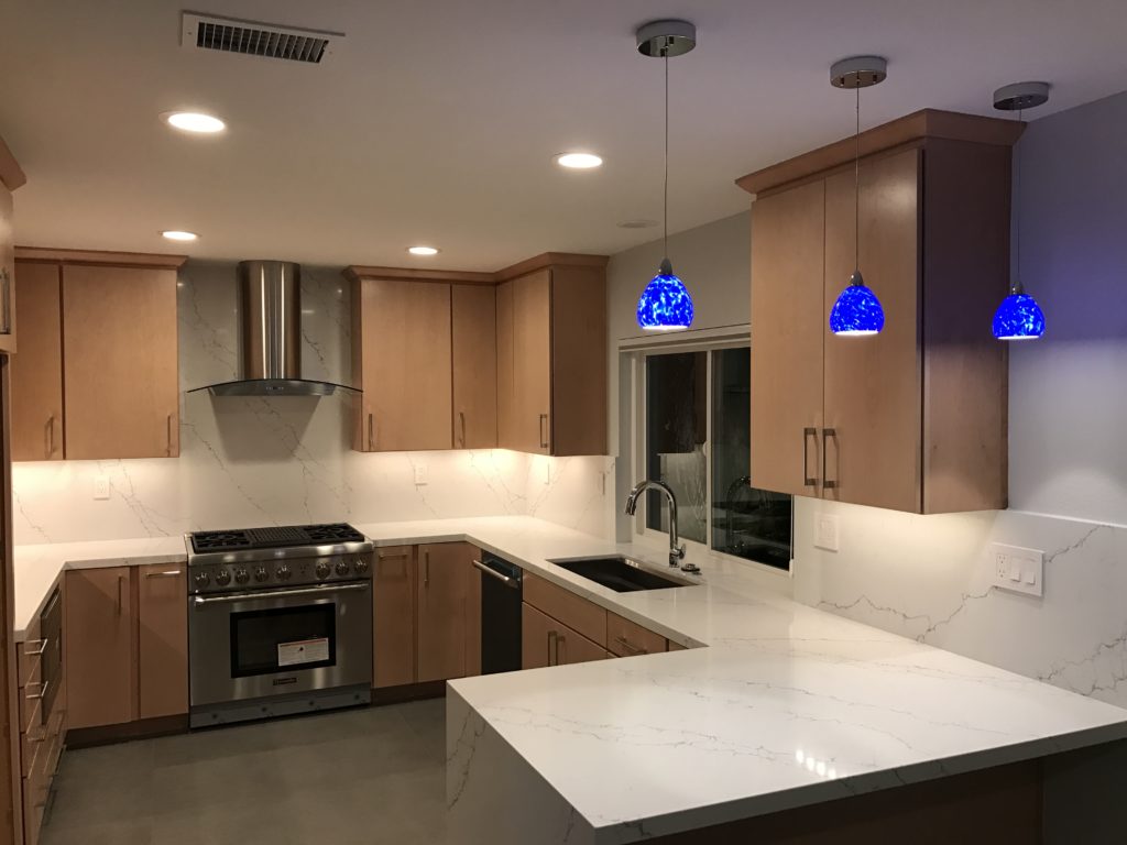 custom kitchen remodeling job added blue lights for accent color to an otherwise neutral kitchen