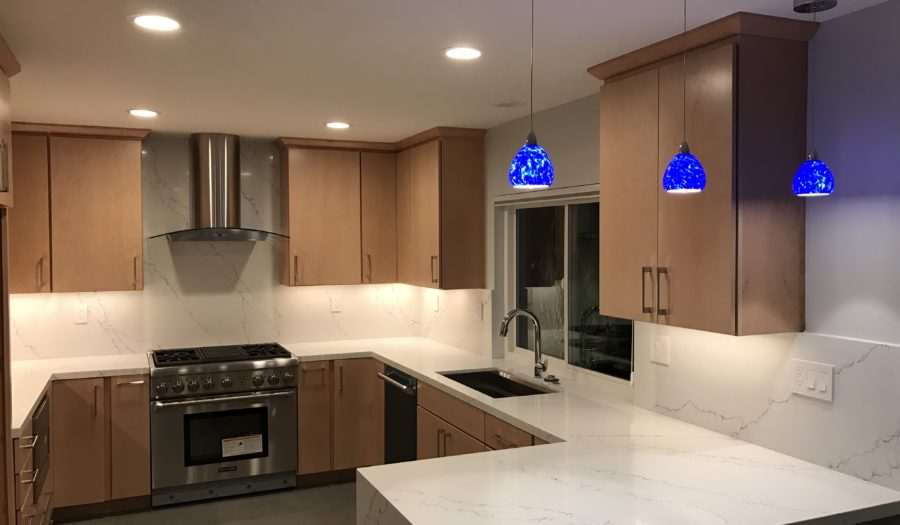 custom kitchen remodeling job added blue lights for accent color to an otherwise neutral kitchen
