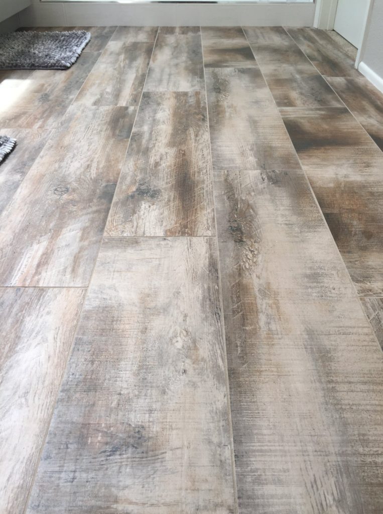 Orange County flooring contractor installs tile that looks like distressed wood in bathrooms for Zen appeal