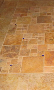 remodeling contractor installed small blue tiles with brown and tan marble