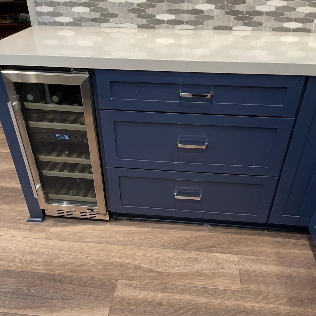 blue custom cabinets have small space for wine storage