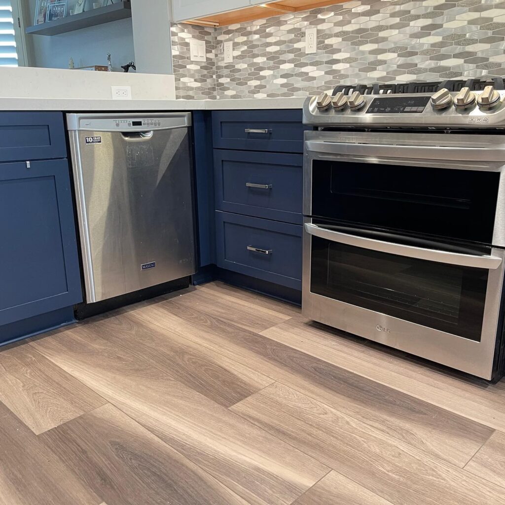 flooring contactor installs wood look tile in modern kitchen