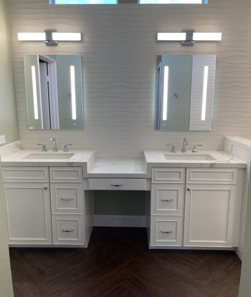 bethroom remodeler adds lighted mirrors to while tile wall