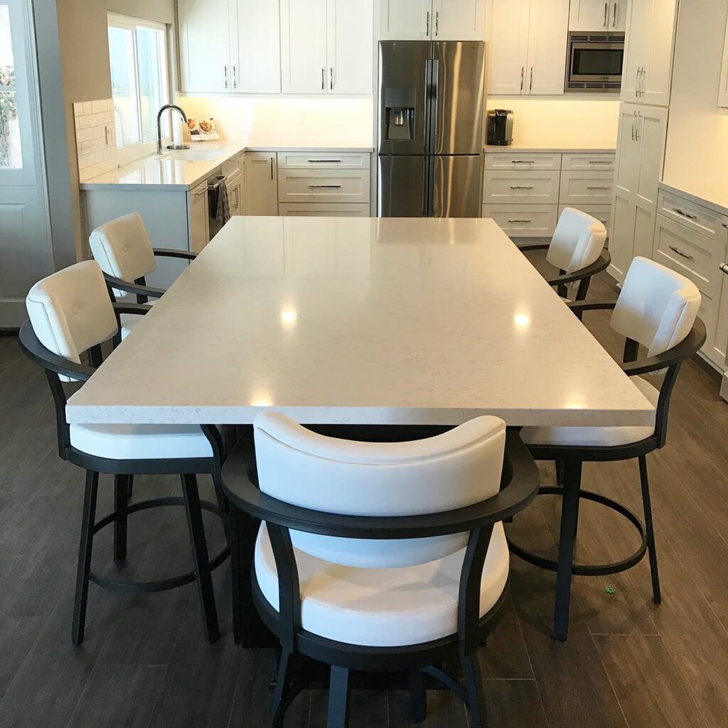 kitchen renovationn project added an eating area with a white table and 5 white chairs