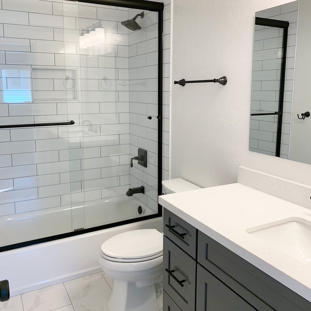 Orange County shower remodel with white subway tile and black fixtures