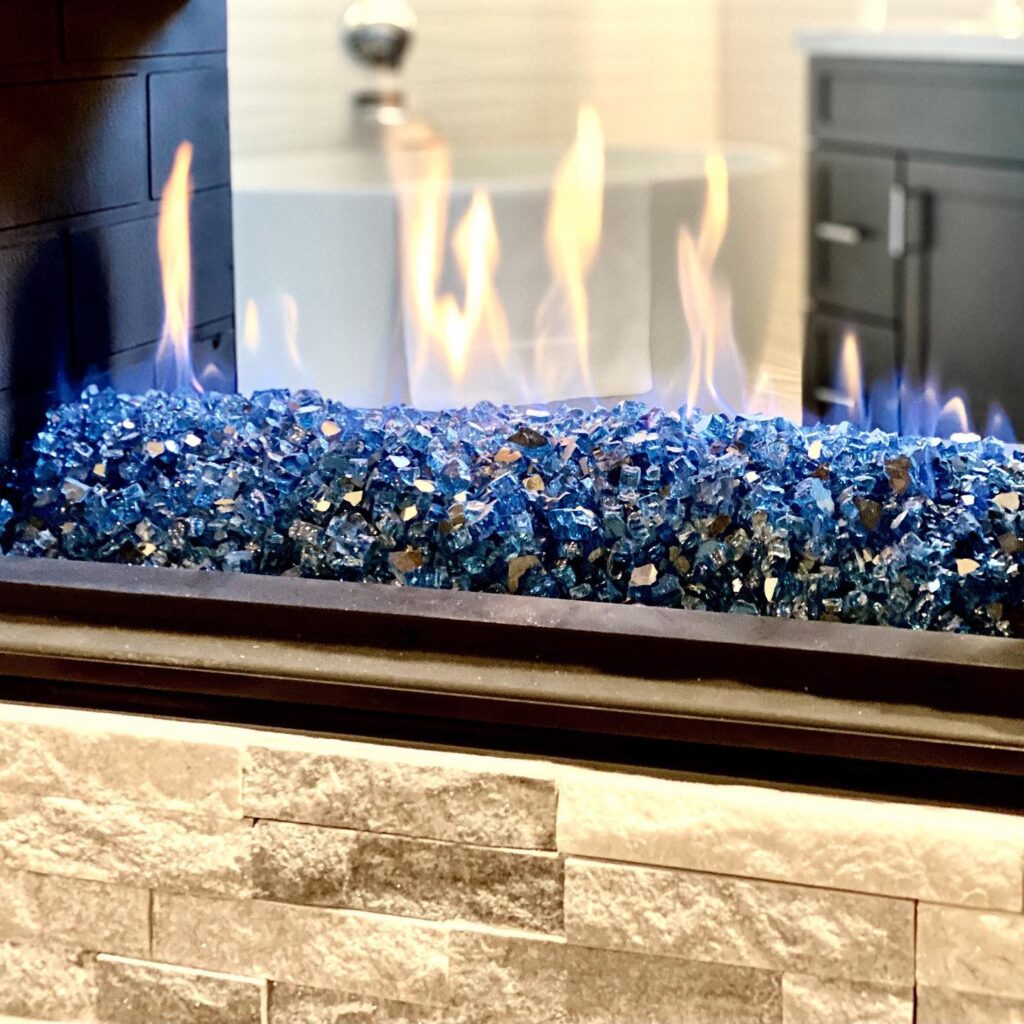 Orange County house remodeling project after picutre with blue glass fireplace in bathroom