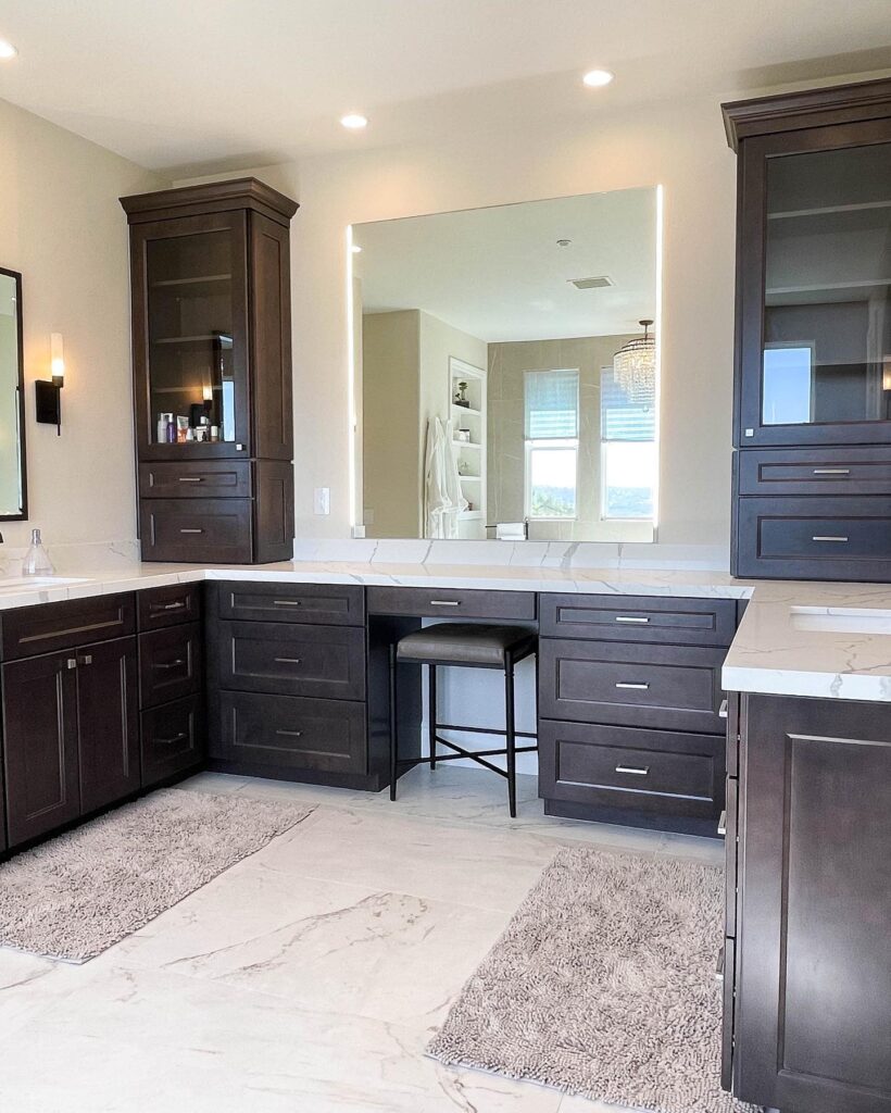 San Clemente bathroom remodeling after photo adds 2 sinks, ebony wood cabintry, white marble vanity and lighted mirror