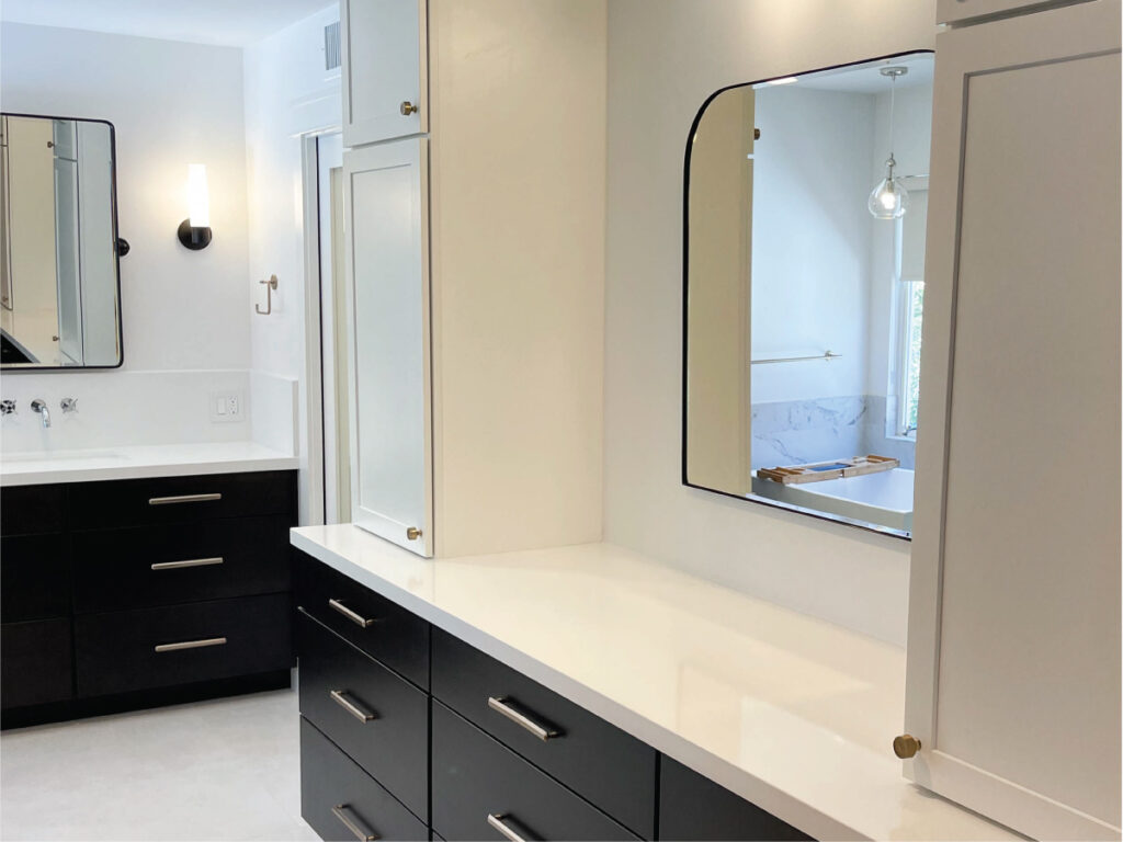 Black slab front custom cabinets with white counters for a modern contemporary bathroom