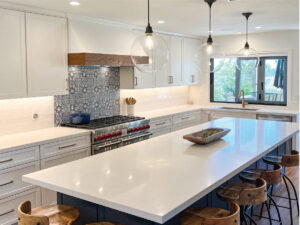 White and navy kitchen cabinets with Spanish influenced backsplash tile