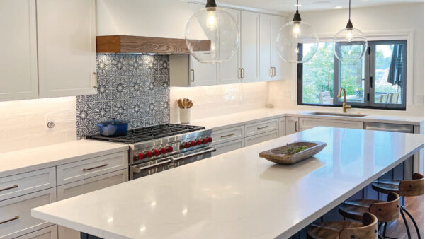 White and navy kitchen cabinets with Spanish influenced backsplash tile