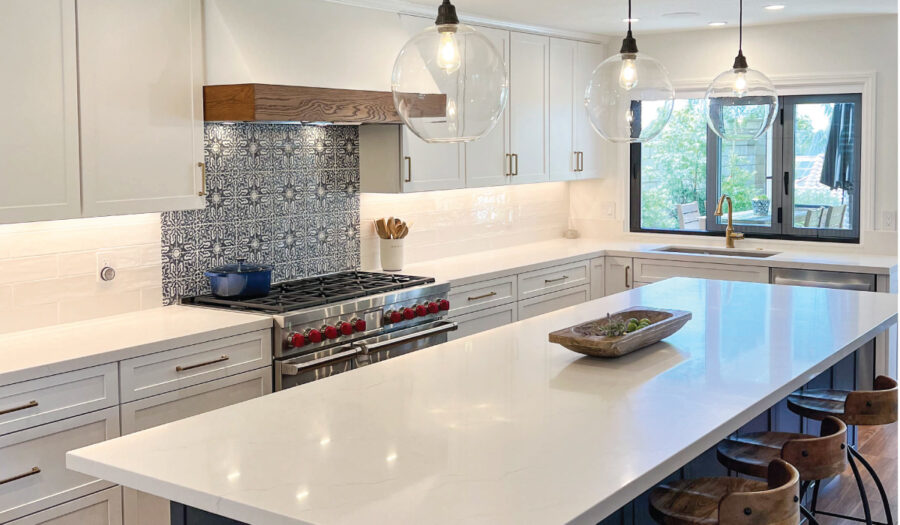 White and navy kitchen cabinets with Spanish influenced backsplash tile