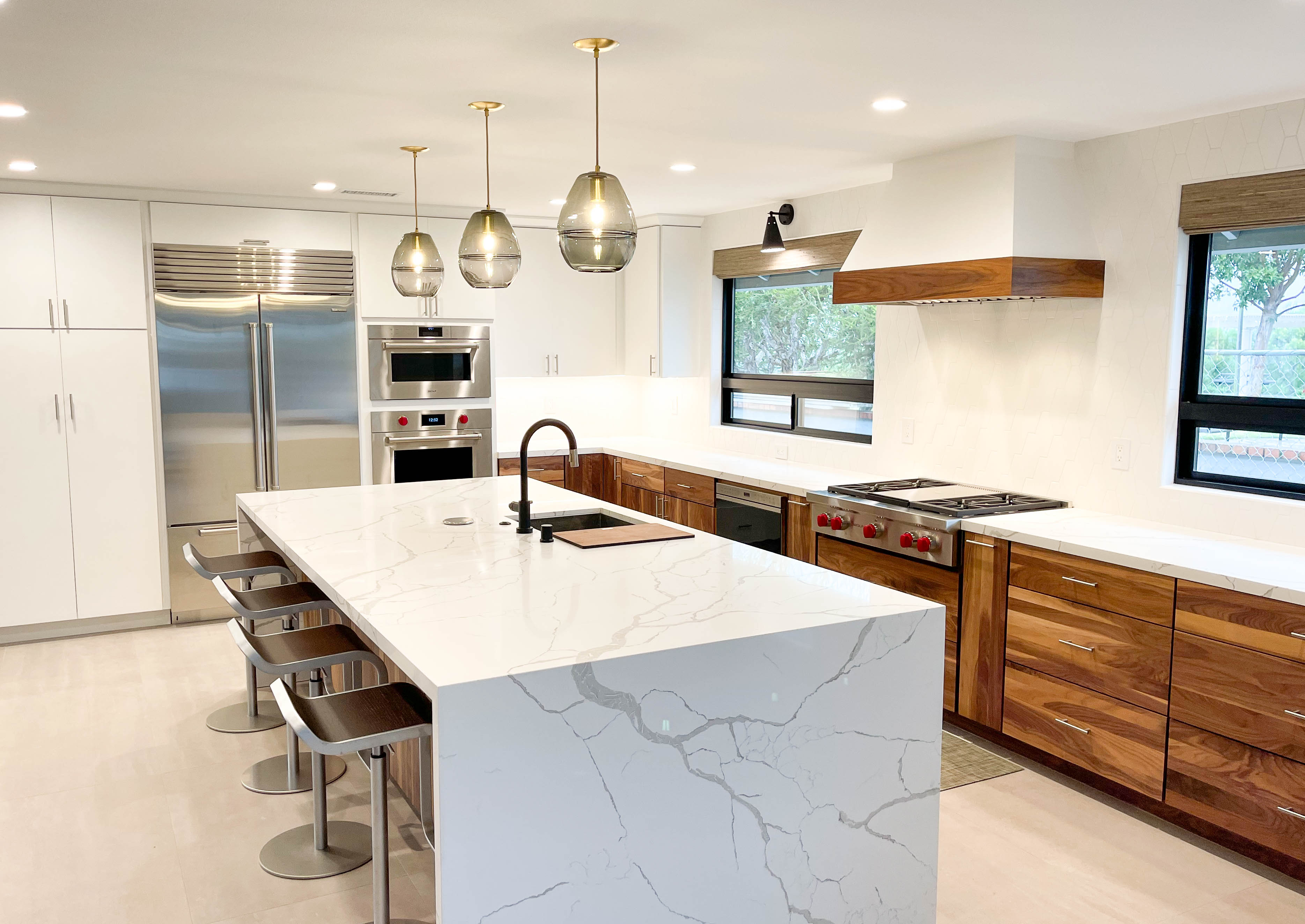 This kitchen hood features wood trim to match custom cabinets