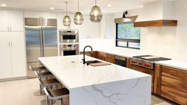 kitchen and bath contractors after photo of kitchen with white marble counters and oak cabinets with stainless steel appliances