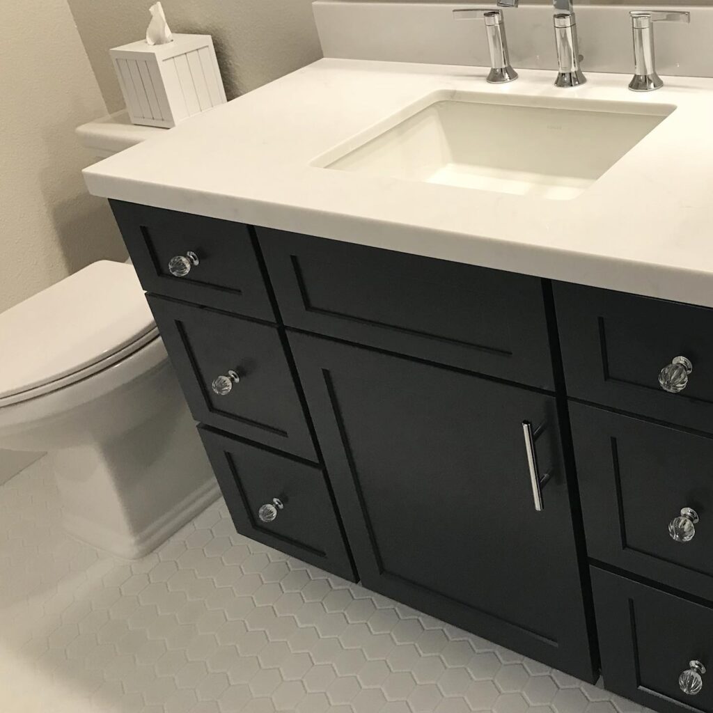 after Orange County bathroom deisgners install white hexagon tile and black espresso cabinet with white marble top in a powder room