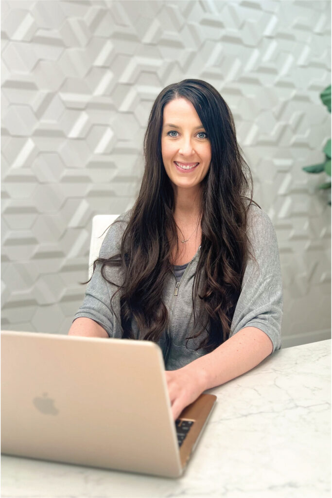 female at computer researching home improvement contractors