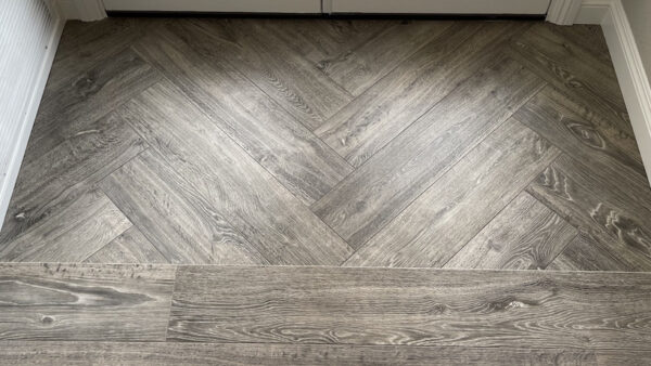 flooring contractor installed herringbone pattern wood planks in home entryway