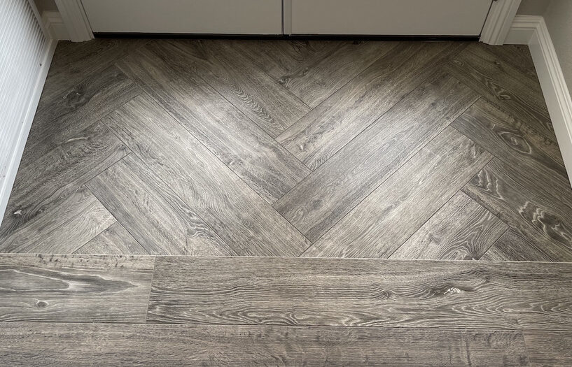 flooring contractor installed herringbone pattern wood planks in home entryway