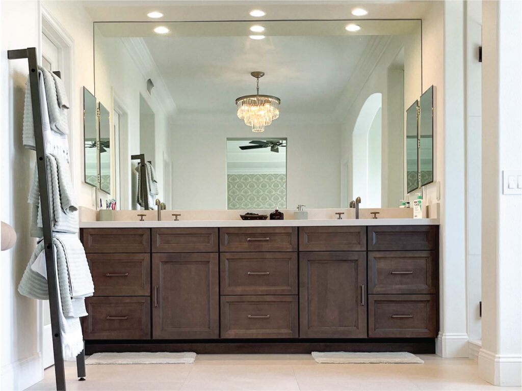 Dark wood vanity with chandelier lighting