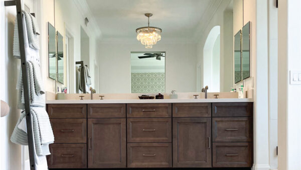 Dark wood custom cabinet vanity with chandelier lighting