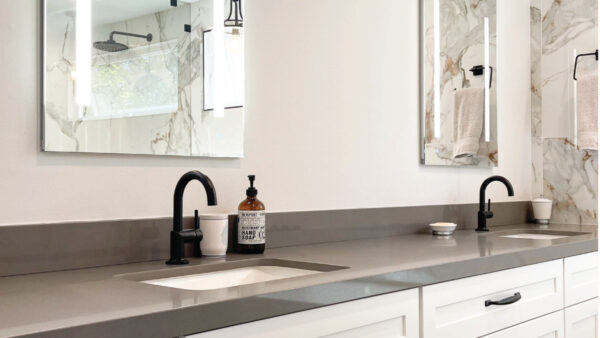 kitchen and bath contractors after photo with Grey quartz countertops with white cabinetry and black accessories