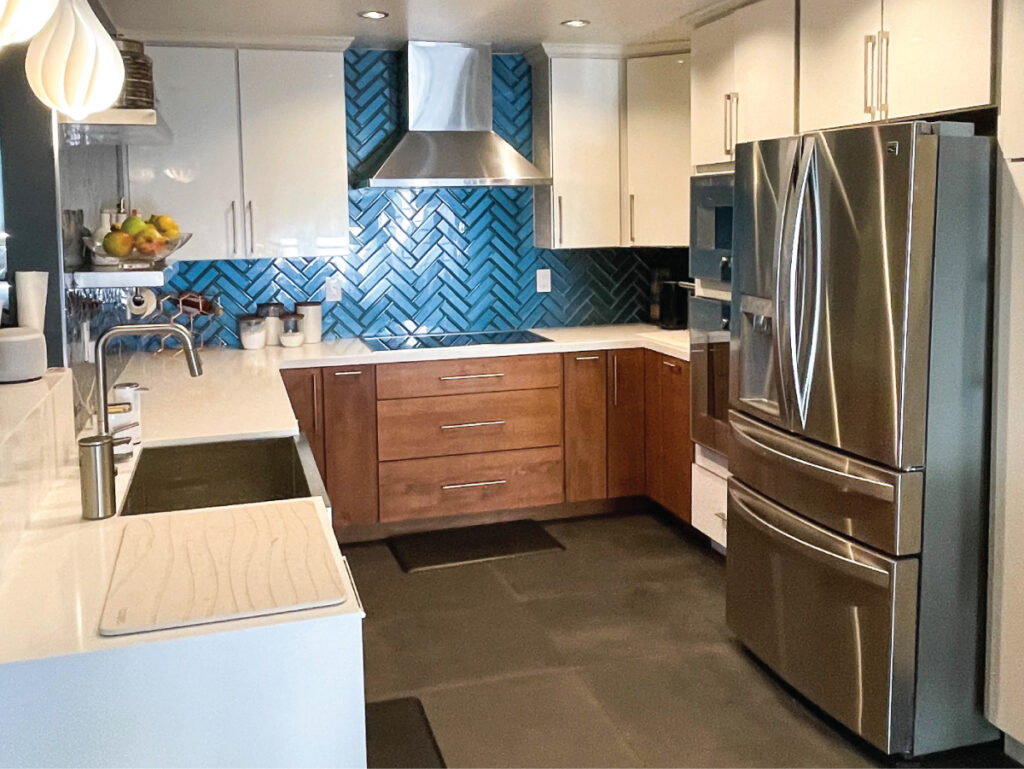 White and walnut kitchen with blue glass herringbone backsplash