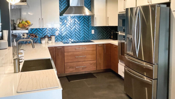 Kitchen remodeler after photo White and walnut kitchen with blue glass herringbone backsplash