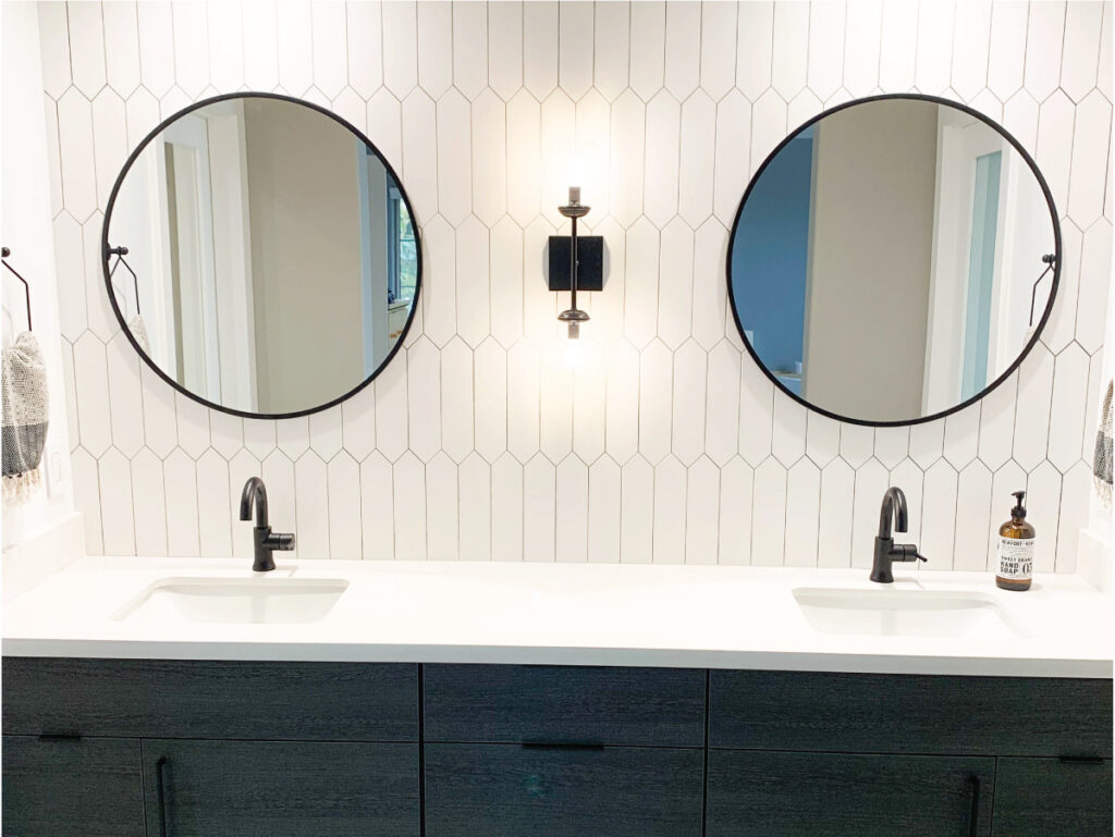 White picket tile backsplash with black accessories and dark cabinets