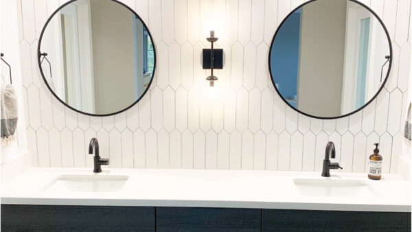 White picket tile backsplash with black accessories and dark cabinets