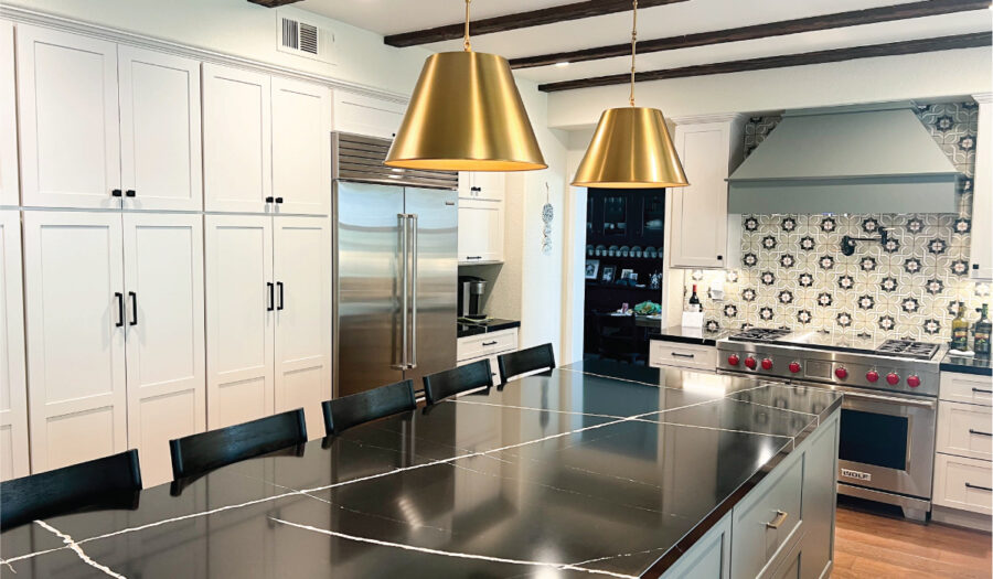 Green & white kitchen cabinetry with black quartz countertops