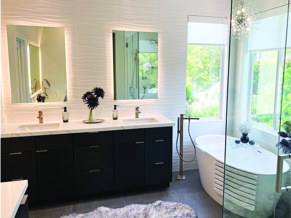 Modern master bathroom with slab front cabinets and white backsplash installed by Orange County remodeler Inspired Remodels