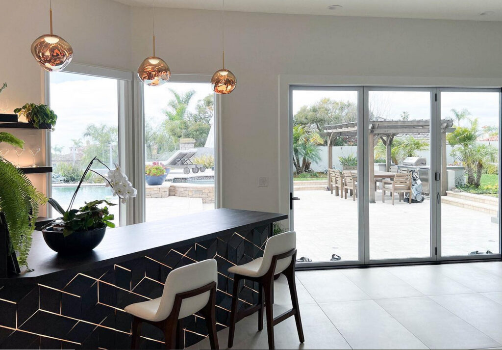 black and white home bar looking out over a pool