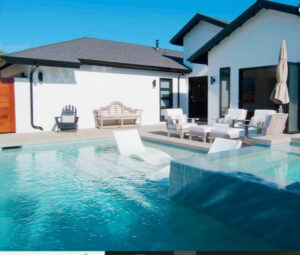 backyard pool with built in lounge chairs