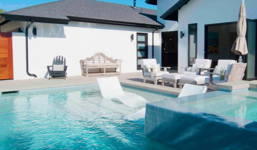 backyard pool with built in lounge chairs