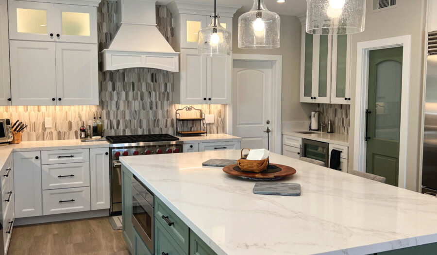 kitchen remodeling after photo stainless sttel stove and hood with gre, black & white backsplash