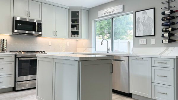 Kitchen with light grey cabinets, white quartz countertops, and light grey tile floors