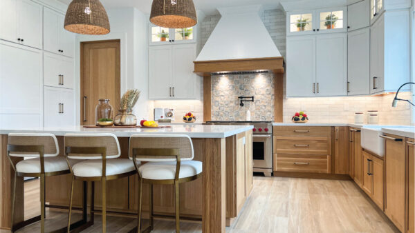White and white oak kitchen cabinetry with pendant lighting and light wood-tone porcelain floors