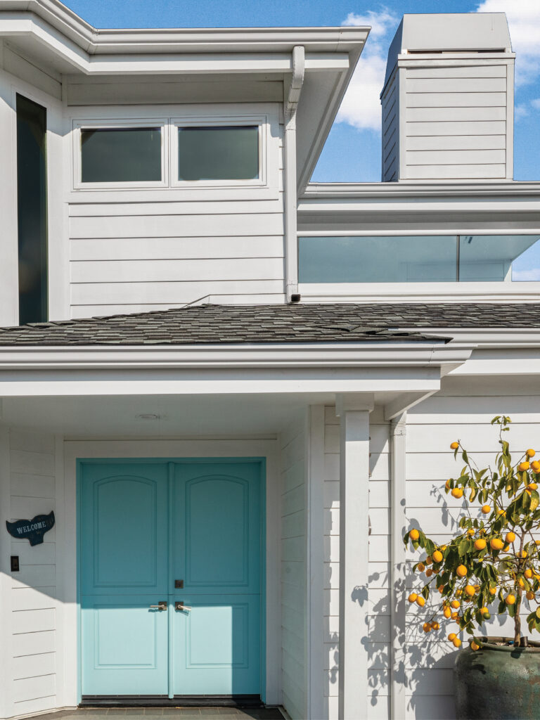 Orange County general contractors after Dana Pont new white siding and aqua front door