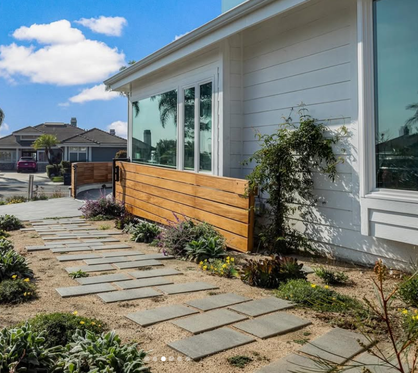 Orange County general contractors after photo with xeriscaping and gray pavers on path by mahagany sliding gate