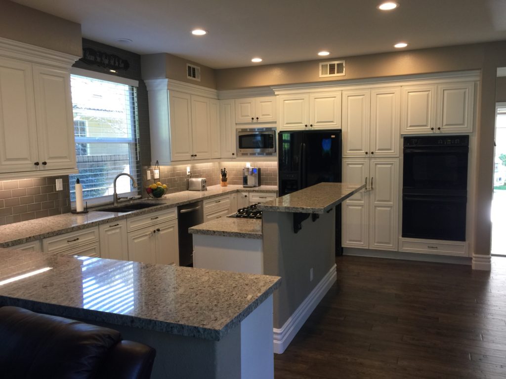 kitchen remodel company moves cooktop to island to cut down number of steps needed to reach the sink